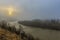 A unique dawn in the Carpathians with fog over a fast river.