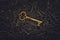 Unique gold key on pile of vintage skeleton keys. Concept for individual or uniqueness, unlocking potential, or stand out from the