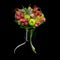 Unique handmade edible gift in the form of a bouquet of fruit standing in glass vase on a black background