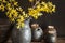 Unique handmade pot with wooden detail for sugar or salt and branches of Forsythia in black vase