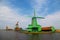 Unique, old, authentic, traditional and colorful dutch windmills along the canal of The Netherlands