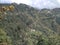 A unique and rare panoramic scene of green hills with clouds in blue sky