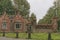 Unique red brick gate house in early autumn