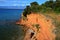 Unique red sand-stone rocks above small stony beach on norhern side of Vir island, Croatia, Adriatic region