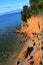 Unique red sand-stone rocks above small stony beach on norhern side of Vir island, Croatia, Adriatic region