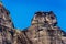 Unique shape formed by hills and white cross of holy trinity at meteora Greece