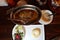 unique steak on silver platter with mashed potatoes and vegetable soup