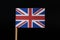 A unique and very powerfull flag of Great Britain on toothpick on black background. Alternating red, white and blue colour