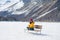 Unique Winter holidays trip to amazing snow valley - young happy and beautiful Asian woman sitting on bench alone enjoying snowy