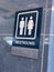 Unisex Bathroom sign on wall with brail