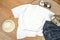 Unisex white shirt , flat lay on wooden boards with blue jeans