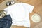 Unisex white shirt , flat lay on wooden boards with blue jeans