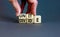 Unite or divide symbol. Concept word Unite or Divide on wooden cubes. Beautiful grey table grey background. Businessman hand.