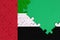 United Arab Emirates flag is depicted on a completed jigsaw puzzle with free green copy space on the right side