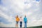 United group purposefully moves forward. Men and woman walks dramatic cloudy sky background. True friendship grow with