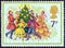 UNITED KINGDOM - CIRCA 1978: A stamp printed in United Kingdom shows Singing Carols round the Christmas Tree, circa 1978.