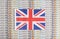 United Kingdom flag on a background from dollar banknotes. Concept of the relationship of the British money in relation to the