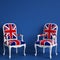 United Kingdom flag chairs on blue background with copy space