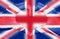 United kingdom flag painted on hands forming a heart on blurred Union Jack background, UK patriotism concept