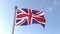 United Kingdom flag waving isolated with blue sky in background. Close up, UK, Great Britain, England, 3d rendering