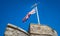 United Kingdom Union Jack flag blowing in the wind on top of Westgate Towers, Canterbury, UK.