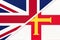 United Kingdom vs Bailiwick of Guernsey national flag from textile. Relationship between two european countries