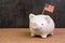 United State economy, investment or financial assets and savings concept ,piggy bank with United state national flag on wood table