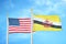 United States and Brunei two flags on flagpoles and blue cloudy sky