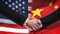 United States and China handshake, international friendship, flag background