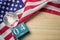 United states flag with crystal glass globe and wooden calendar on wood background