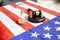 United states flag with wooden gavel and hourglass on it