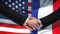 United States and France handshake, international friendship, flag background