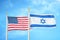 United States and Israel two flags on flagpoles and blue cloudy sky