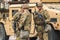 United States Marine Corps soldiers with weapons, helmets and armored vehicle humvee