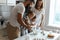 United young family preparing homemade birthday cake