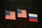 Unites States and Russian Federation flags raised during women\'s all-around gymnastics medal ceremony at Rio 2016 Olympics