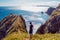 Unity with nature. Girl on background of beautiful wildlife, sea and rocks