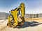 Universal excavator or loader with folded bucket at construction site. Universal construction equipment. Rental of construction