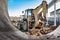 A universal excavator or loader is working on a construction site against a cloudy sky. Earthworks at a construction site. Modern