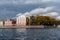 Universitetskaya embankment in St. Petersburg. Facade of houses. View from the water. Sunny day. Autumn