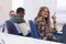 University female student in classroom sits at her desk turning to smile at the camera during class