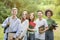 University Friends. Outdoor Portrait Of Diverse Multiracial Students With Workbooks Posing Together