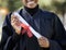 University graduation, diploma and hands of black woman with award for studying achievement. Closeup graduate student