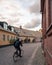 A university student runs his bike along the small cobblestoned streets bordered with colorful houses in the old town of Lund,