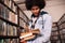 University student standing in library with lots of books