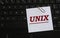 UNIX - word on a white sheet against the background of the laptop keyboard