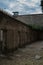 Unkempt Courtyard of an Old Prison Full of Weeds and Cells