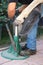 Unknown blacksmith working with a horseshoe outdoors summertime