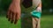Unknown boy hand holding soccerball closeup. Child arm keeping ball on meadow.