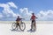 Unknown boys with a bicycle on a sandy beach at low tide on the island of Zanzibar, Tanzania, East Africa